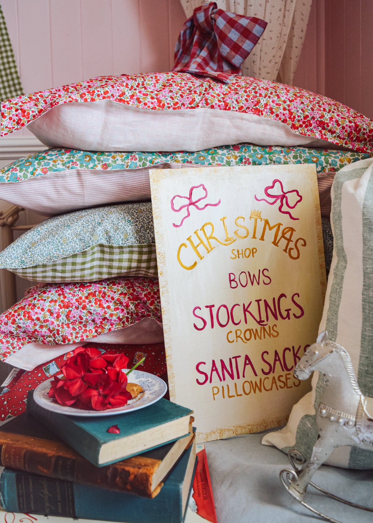 Stack of Liberty Christmas Pillows with vintage inspired Christmas Shop sign